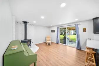 Spacious family room off of the kitchen offers a second living and gathering space, with a slider to the covered rear patio and yard