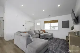 The living room is open to the dining and kitchen for a perfect multi-entertaining great room