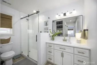 Notice the glass sliding shower entry of the primary bathroom