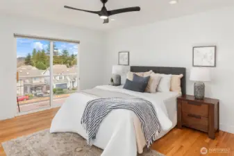 Primary bedroom with sliding door to view deck.