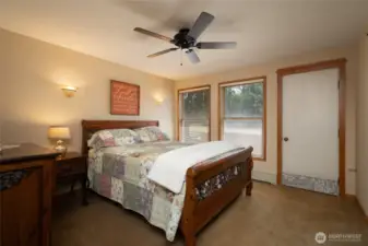 Primary bedroom on main floor with access to deck with hot tub.
