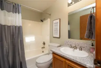 Full bath on main floor with granite countertops.