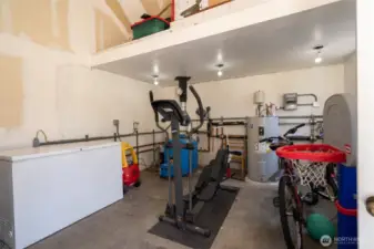 Inside the mechanical building that holds the multi-zone radiant heating system, the Burerus Boiler that heats house and hot water tank with timed circulators for instant hot water, freezer and more storage.