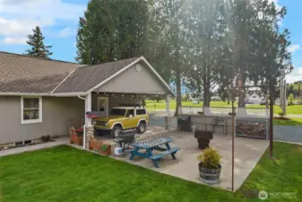 Back porch & carport with sports slab with basketball hoop. Outdoor lighting on switch.
