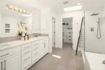 Updated five piece primary bathroom with large walk in show and built in closet system.
