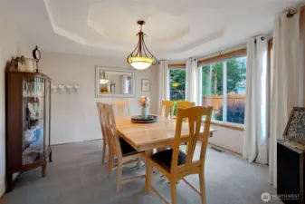 Situated between the kitchen and living rooms, the dining room showcases a large window overlooking the stunning backyard and offers an inviting space perfect for entertaining.