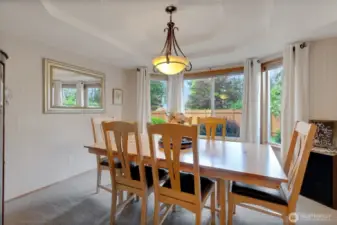 Situated between the kitchen and living rooms, the dining room showcases a large window overlooking the stunning backyard and offers an inviting space perfect for entertaining.