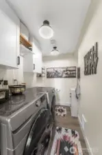 Laundry room with storage located downstairs