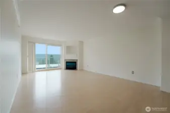 The Light and Bright Great Room has a Gas Fireplace and Sliders Out to the View Deck