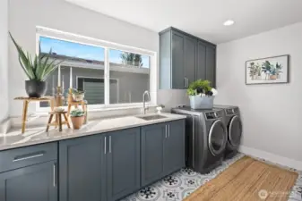 Laundry room with counter and sink upstairs.