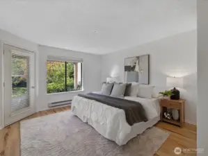 The primary suite includes this very spacious bedroom with doors to the covered patio.