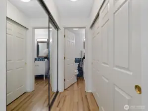 Double closets lead to the primary bath. This home has more than generous storage space.