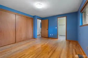 Primary bedroom with a wall of closets and primary bath.