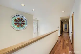 The upper hallway leads to the other 3 bedrooms and guest bath on the west end of the home, which affords excellent separation from the Primary Suite.