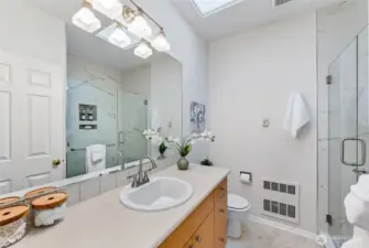 The spacious primary en-suite bathroom has been beautifully updated, combining modern style with comfort.