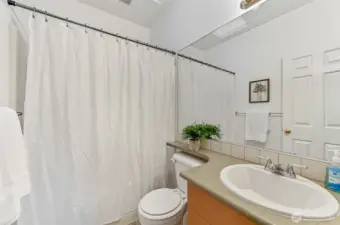 A generously sized full guest bathroom provides ample space and convenience.