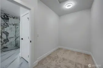 Walk-in closet in primary suite (photo of similar home in separate community)