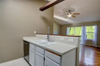 Open concept kitchen with the dining and living area. Oversized windows keep the area bright.