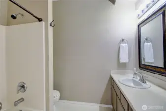 The oversized hallway guest bath has a shower/tub combo.