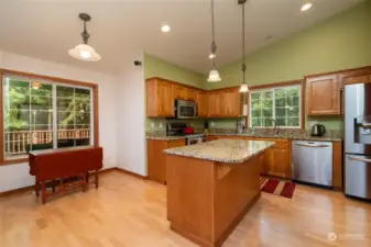 Kitchen with beautiful slab granite counters, lots of prep area, Stainless Appliances and beautiful wood cabinets!