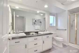 3/4 primary remodeled bath with dual sinks, new luxury vinyl plank flooring.