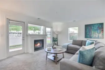 Wonderful living spaces - Living room features lovely gas fireplace, lots of windows, and door to one of two generous sized patios.