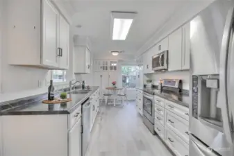 Remodeled kitchen/nook is gorgeous. Brand new luxury vinyl plank flooring. Great use of space.