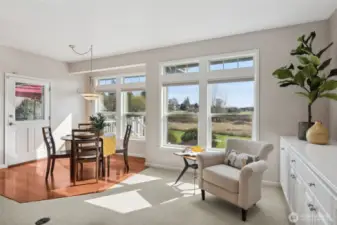 Ready for a daily dose of awe? This family room flaunts built-ins for all your storage needs while framing jaw-dropping views of Mt. Rainier through not one, but two stunning sets of windows. The casual dining area peeks into the scene, making this space  perfect for entertaining or family gatherings. It’s not just a room; it’s a front-row seat to nature’s best performance!