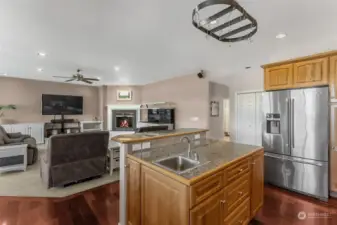 Note the chic stainless steel French door fridge with a bottom freezer and convenient water/ice dispenser, it has everything you need at your fingertips. With upper cabinets for extra storage, you’ll never run out of space. As you whip up your favorite meals, enjoy the open view into the family room, perfect for keeping the conversations flowing. And don’t forget the practical storage closet nearby—ideal for keeping everything organized.