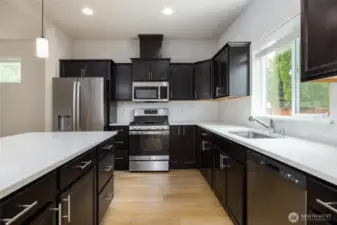 Kitchen has spacious island with eating bar.