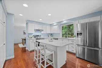 Stainless Steel appliances and refreshed kitchen with updated cabinets and quartz counters.