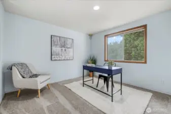 Extra flex space/office overlooks to below into the living room.