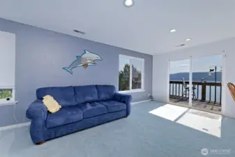 Sunny living room just off of the kitchen, with a slider to the deck.