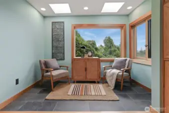 Main floor bedroom with hardwood floors, sunroom addition (skylights, Anderson windows, heated stone floors - $80,000 project), custom cedar wood bump out shelves and armoire.