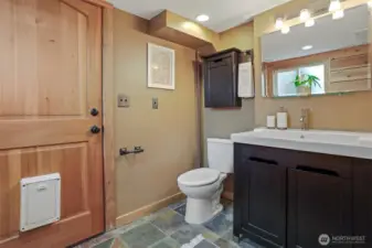 Lower level remodeled 3/4 tiled bathroom with heated stone floors and stone tiled shower.