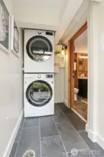 Laundry room has outside entry so can be shared with the Cottage.  Features:  Full size stack Washer and Dryer and Stone tiled floors.