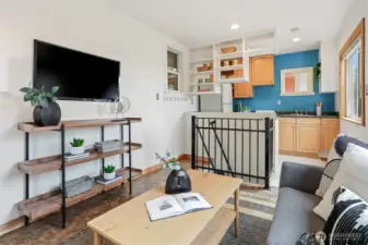 Cottage upper level living room with cork floors, cedar trim, recessed lights and westerly territorial views.
