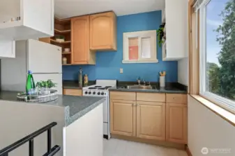 Cottage kitchen opens to living area.