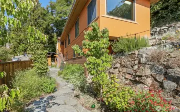 Professionally architect designed ($50,000 project)  fenced courtyard with access to the Main south home lower level and custom built cedar shed.