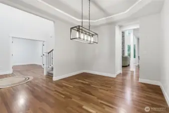 Charming dinning room featuring crown molding and cove ,lighting.