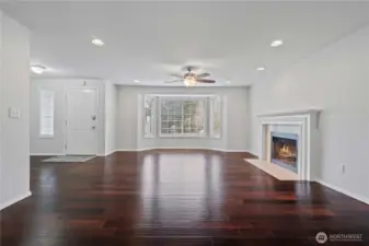 Gleaming hardwoods, bay windows and a elegant fireplace makes this living room a showcase