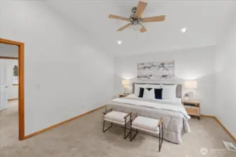 Primary bedroom with carpeted flooring, ceiling fan, and recessed lighting. Neutral finishes and generous floor space allow flexible furniture placement.