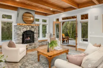 The living room opens to the two level patio. There are window seats on each side of the fireplace.