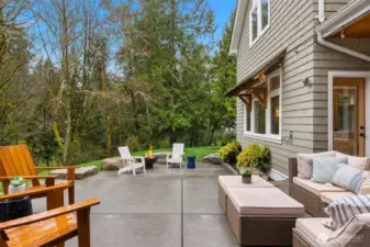Designer patio with inset boulders, two levels and forest views.