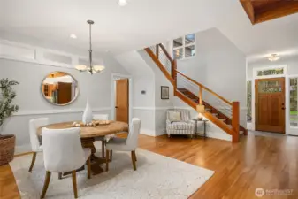 Looking from the dining area. Entry on the right and the custom stairway with the primary suite to the left.