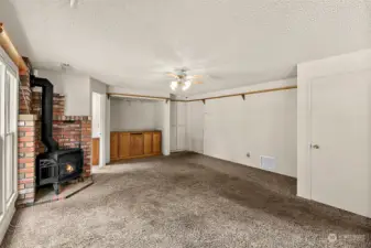 Additional living room with another wood burning stove & closet space.