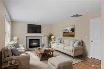 The Family room features a natural gas fireplace and array of windows to bring in an abundance of natural light.  Virtually furnished to show versatility