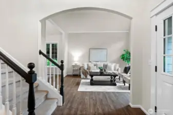 A beautiful arched doorway leads to a formal living room where you can host your loved ones whether it is a large or small gathering.