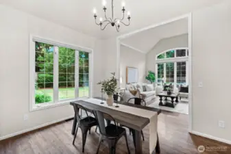 The floor plan is open and airy with easy transitioning from room to room. Luxury vinyl plank flooring throughout the main level blend one room to the next seamlessly for a unified and aesthetically pleasing look.
