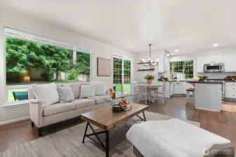 The great room flows into the kitchen area with access to the backyard via sliding glass doors.